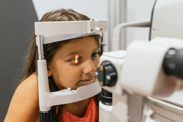 Young patient undergoing eye examination with modern equipment