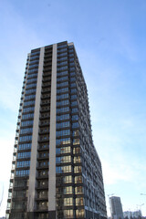 Naklejka premium modern high-rise building under construction in a new residential complex, modern architecture in the city, facades of new buildings