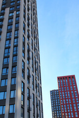 Obraz premium modern high-rise building under construction in a new residential complex, modern architecture in the city, facades of new buildings