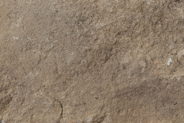 Stone texture in earthy brown tones with natural rugged details for backgrounds.