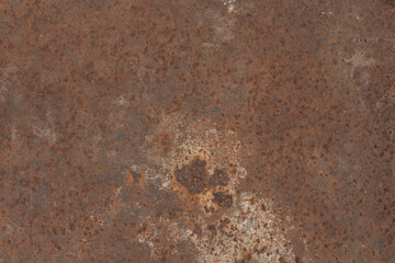 Rusted metal surface with vibrant orange and brown tones and detailed textures.