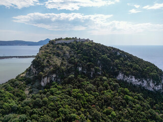 Aerial View of Historic Hilltop Fortress Surrounded by Lush Greenery and Coastal Scenery in Greece