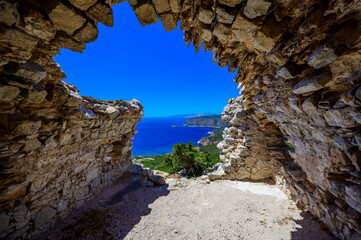 Monolithos Castle in paradise landscape scenery - travel destination on beautiful island Rhodes, Greece
