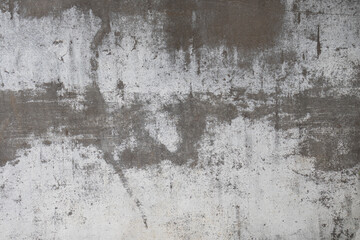 Fototapeta premium A weathered gray surface with abstract patterns and rough textures.