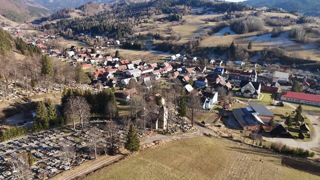 Aerial Drone View of an Old Church in the Middle of a Cemetery in Rural Landscape, Rotating View