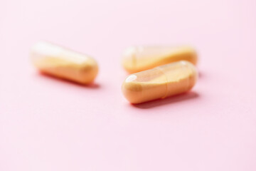 Coenzyme Q10 capsules. Antioxidants. Concept for a healthy dietary supplementation. Bright paper background. Soft focus. Close up. Copy space.	