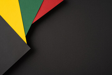 Abstract arrangement of vibrant colored papers against a black backdrop, ideal for designs