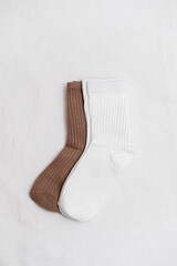 These stylish ribbed socks, available in an elegant white and brown, are perfect for both casual and formal wear.