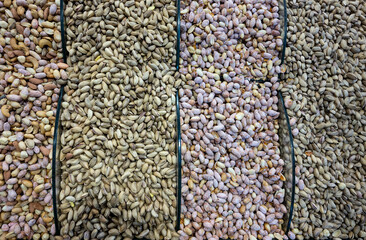 Top view photo of various roasted nuts including pistachio, peanuts, almonds, cashews and hazelnuts on display near Spice Bazaar market area in Istanbul, Turkey