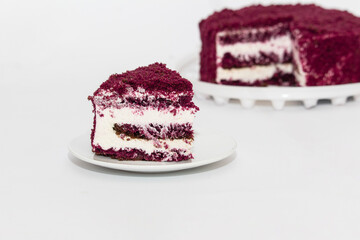 Red Velvet Cake is a traditional red chocolate cake with white buttercream on white background