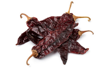 Heap of dried Mexican guajillo chili peppers isolated on white background close up