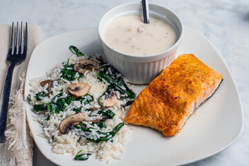 seasoned salmon  served with rice , spinach and mushrooms