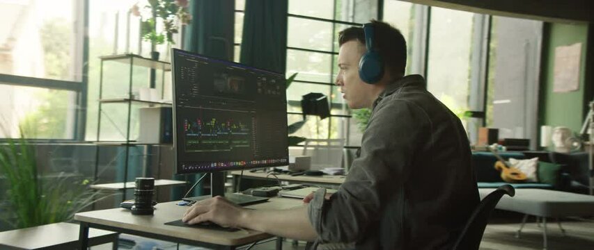A modern and vibrant workspace featuring a bright yellow background and a sleek computer setup