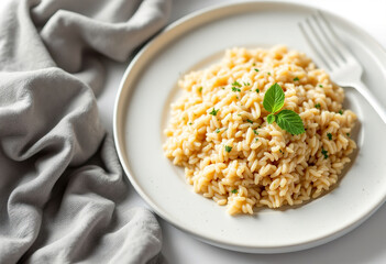 A photo of a white plate with a creamy risotto isolated on white background