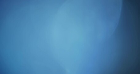 Abstract Blue Bokeh Background Texture.  Can also be used as an overlay for a retro film effect.