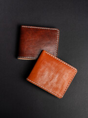 Blank brown men's leather wallet isolated on black background, perfect for leather industry catalog design