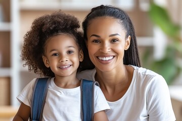 A mother and her daughter are beaming with joy as they pose together, showcasing their strong bond and the happiness that comes from shared moments and love.