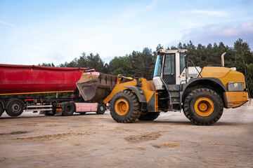 WWheel front loader at a construction site in a quarry. Powerful modern equipment for earthworks. Construction site. Heavy wheel loader at work.