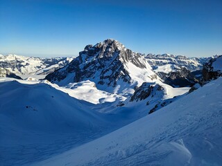 Obraz premium Ski tour in the Glarus Alps with a view of the Mürtschenstock near the Schilt. Ski mountaineering in winter. Winter mountain landscape. High quality photo