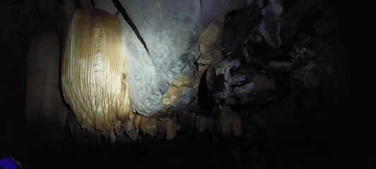 tropical cave with a river and stalactides