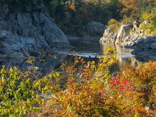 Two kayakers on the river in fall