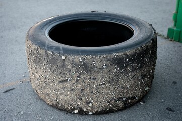 A worn-out tire covered in dirt and debris.