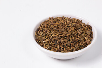 Caraway Seeds in a White Bowl: Aromatic Spice Close-up