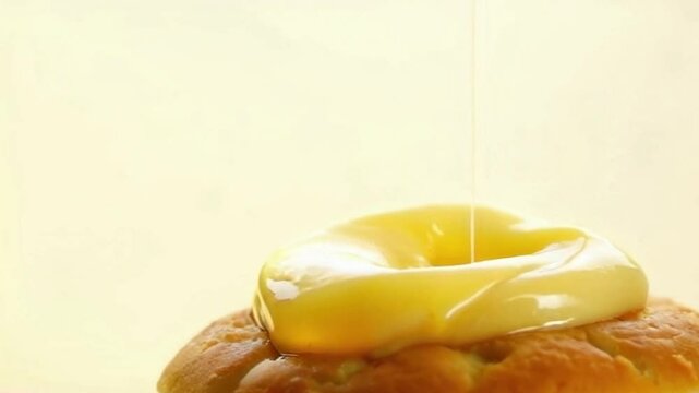 Lemon cronut bursting with yellow lemon filling ribbons, vibrant color with pastel yellow background, fresh energy