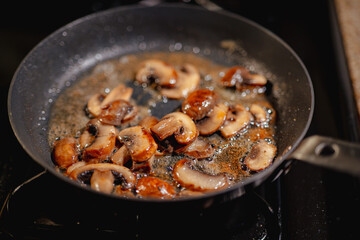 sautéed mushrooms in a skillet on a stove 
