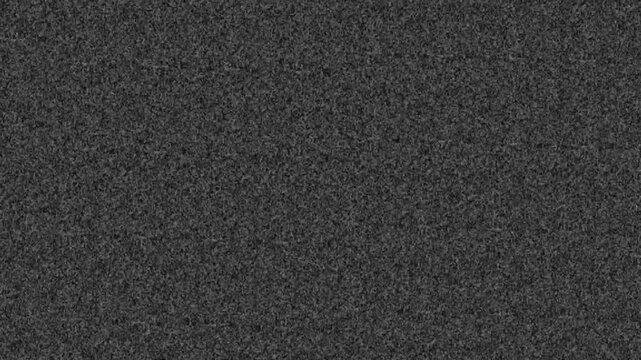 digital noise A close up of a white and gray noise with a grainy texture. The pattern of tints and shades create a contrast with the dark background, giving it a peach and carmine undertone. TV