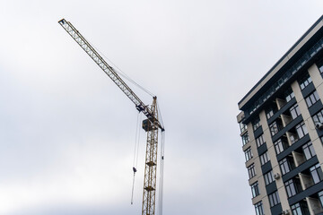 Crane on the background of a new house