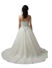 Fototapeta premium A woman in a strapless white wedding gown with a lace-up back stands facing away from a plain background.