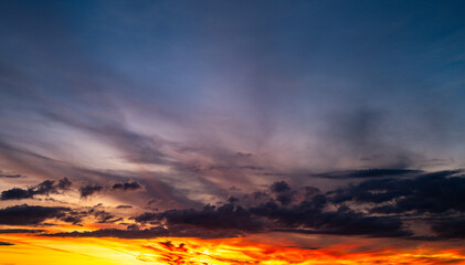 Sunset background. Dramatic sunset. Sky with clouds in sunset sky light background. Sunrise with clouds dawn sky. Calm sunset sky and sun through clouds over.