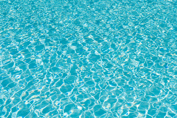 Summer vacation. Spa resort on summer vacation. Pool side resort with pool water surface background. Sea ripples on blue pool background. Sea background. Swimming pool rippled. Poolside lounge