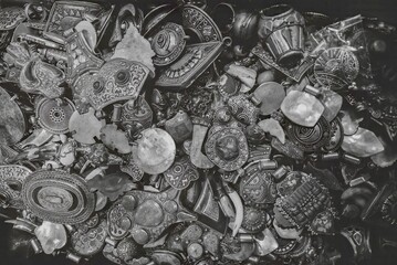 A black-and-white photograph of intricate jewelry pieces, highlighting their detailed craftsmanship and cultural significance.