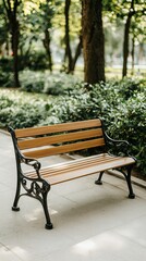 Obraz premium Relaxing garden area features a wooden bench and concrete table surrounded by greenery and scattered leaves for a peaceful retreat