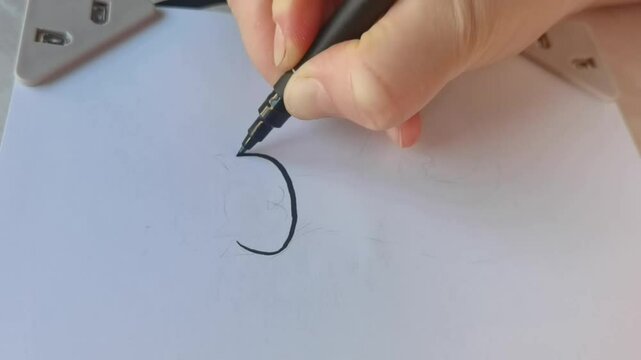 Hand drawn calligraphy artistic process of creating elegant lettering with precision.