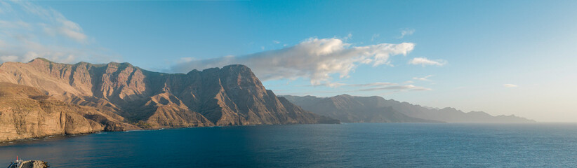Aerial view of West coast of Gran Canaria, Spain. Mountains overlooking the sea, rugged coastline and Atlantic Ocean. Puerto de las Nieves. Canary islands