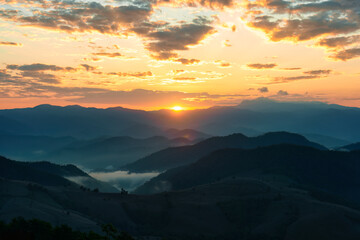 Golden sunrise over mountain with foggy in countryside
