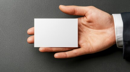 Hand offering blank business card office environment high-definition closeup professional perspective networking concept
