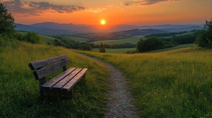 Serene sunset view from a bench on a hilltop trail.