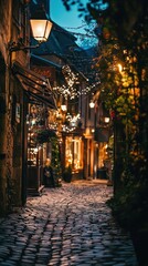 Obraz premium Charming cobblestone street illuminated by warm lights at dusk