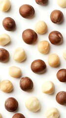 Shelled and unshelled macadamia nuts on white background