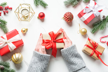 Christmas presents on white background. Woman giving present box, holiday background. Top view.