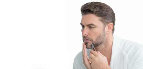 Millennial hispanic man looking in mirror in bathroom, facial skin and stubble. Male beauty care product. Skincare, home spa. Beauty portrait of a beautiful man. Spa, moisturizing nourishing creme.