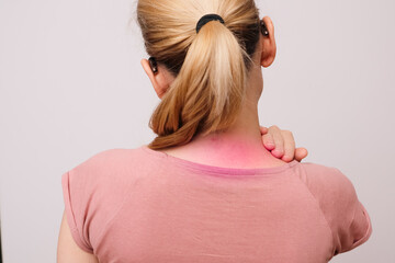 Woman rubbing sore neck. Back view of unrecognizable woman touching and massaging her neck. Joint...