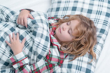 Bedding child. Kid sleeping in bed. Child sleeping in bed under blanket. Kid lying on pillow, child rest asleep, enjoy healthy sleep or nap.