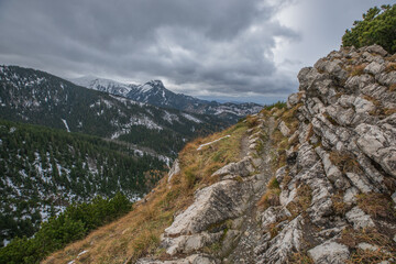 Mountain top, path, rocks, forest in the distance, clouds