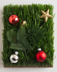 Christmas ornaments and holiday decor arrangement display. Unique holiday scene with ornaments on pristine green grass background for festive concept.