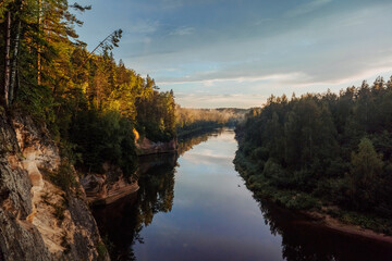A river that flows through the forest and along the cliffs